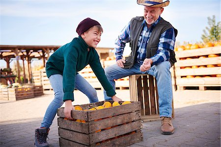 Farmer and grandson at pumpkin farm Stock Photo - Premium Royalty-Free, Code: 649-09035946