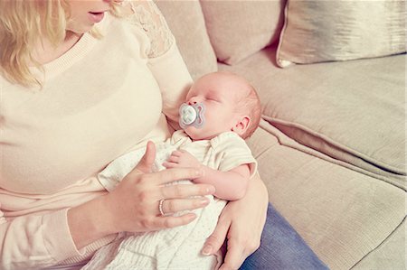 pacifier mom holding - Newborn baby boy, sleeping in mother's arms Stock Photo - Premium Royalty-Free, Code: 649-09036147