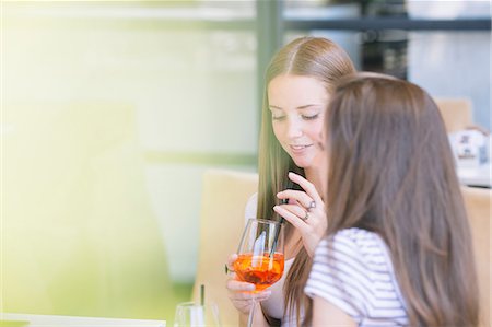 simsearch:649-08824511,k - Two young female friends drinking cocktails at sidewalk cafe Stock Photo - Premium Royalty-Free, Code: 649-09036306