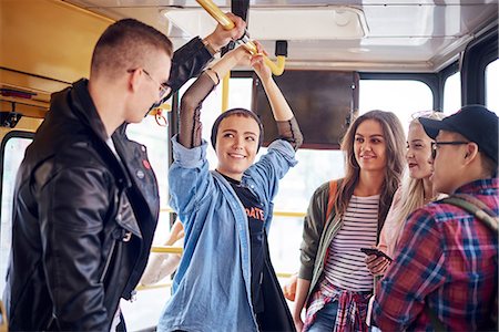 Five young adult friends chatting on city tram Stock Photo - Premium Royalty-Free, Code: 649-09061449