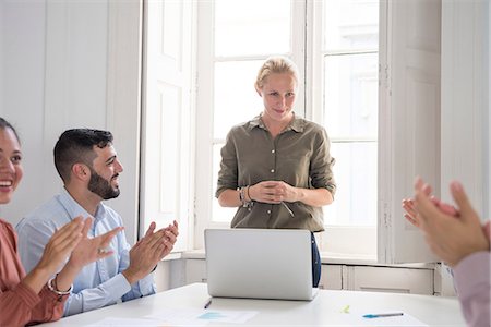 simsearch:649-07710425,k - Young businesswoman applauded for presentation at boardroom table Stock Photo - Premium Royalty-Free, Code: 649-09061468