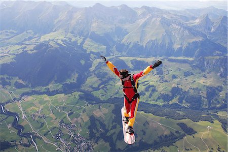 sky-diver (male) - High angle view of skydiver surfing on sky board over mountains Stock Photo - Premium Royalty-Free, Code: 649-09061480