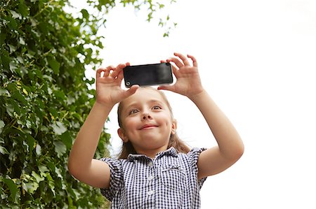 simsearch:649-09139274,k - Young girl, outdoors, taking photograph using smartphone, low angle view Stock Photo - Premium Royalty-Free, Code: 649-09061497