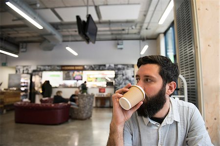 simsearch:649-09061548,k - Man drinking from disposable cup in coffee shop Stock Photo - Premium Royalty-Free, Code: 649-09061542