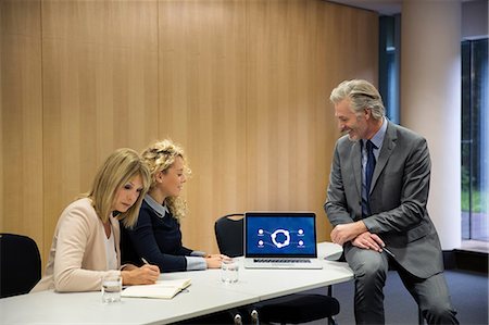 simsearch:649-08824281,k - Colleagues in conference room having meeting, using laptop Stock Photo - Premium Royalty-Free, Code: 649-09061588