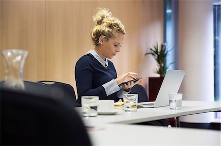 rear view of woman texting cellphone - Woman in office texting on smartphone Stock Photo - Premium Royalty-Free, Code: 649-09061597