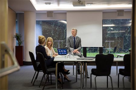 simsearch:649-08824281,k - Colleagues in conference room having meeting Stock Photo - Premium Royalty-Free, Code: 649-09061591