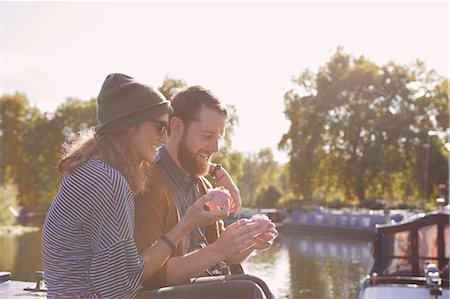 simsearch:649-09061651,k - Couple eating cupcakes on canal boat Stock Photo - Premium Royalty-Free, Code: 649-09061654