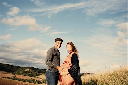 romance - Portrait of pregnant mid adult couple on rural hillside Stock Photo - Premium Royalty-Free, Code: 649-09061901