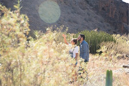 simsearch:649-09148718,k - Young hiking couple looking up and pointing from sunlit valley, Las Palmas, Canary Islands, Spain Foto de stock - Sin royalties Premium, Código: 649-09061924