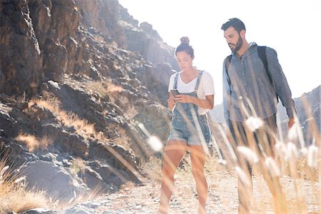 simsearch:400-06424454,k - Young hiking couple looking at smartphone while hiking in valley, Las Palmas, Canary Islands, Spain Foto de stock - Sin royalties Premium, Código: 649-09061921