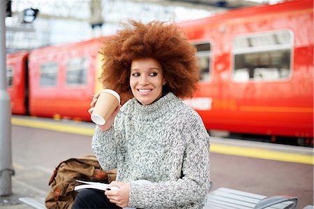 Woman on bench on train station platform, London Stock Photo - Premium Royalty-Free, Code: 649-09078042