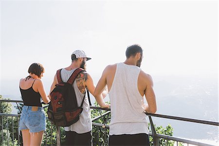 simsearch:649-09078282,k - Three young hipster friends looking out at lake Como from balcony, Como, Lombardy, Italy Stock Photo - Premium Royalty-Free, Code: 649-09078239