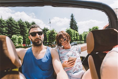 Young couple in off road vehicle on road trip, Como, Lombardy, Italy Stock Photo - Premium Royalty-Free, Code: 649-09078262