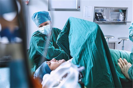 simsearch:649-09078375,k - Surgeons preparing patient for surgery in maternity ward operating theatre Stock Photo - Premium Royalty-Free, Code: 649-09078370