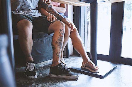 simsearch:649-09078437,k - Waist down of multi ethnic hipster couple in cafe with hand on each others knee, Shanghai French Concession, Shanghai, China Stock Photo - Premium Royalty-Free, Code: 649-09078398