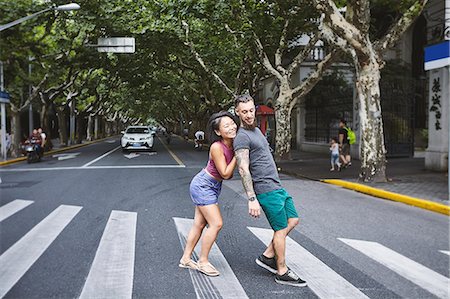 simsearch:649-09078403,k - Woman pushing boyfriend on pedestrian crossing, Shanghai French Concession, Shanghai, China Stock Photo - Premium Royalty-Free, Code: 649-09078426