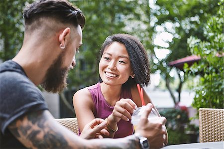 simsearch:649-09078412,k - Multi ethnic hipster couple talking at sidewalk cafe, Shanghai French Concession, Shanghai, China Fotografie stock - Premium Royalty-Free, Codice: 649-09078429