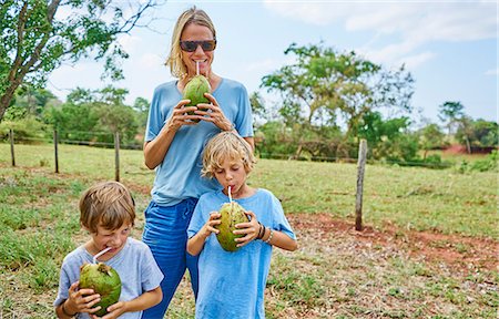 Family drinking through straws from coconut, Bonito, Mato Grosso do Sul, Brazil, South America Stock Photo - Premium Royalty-Free, Code: 649-09078629