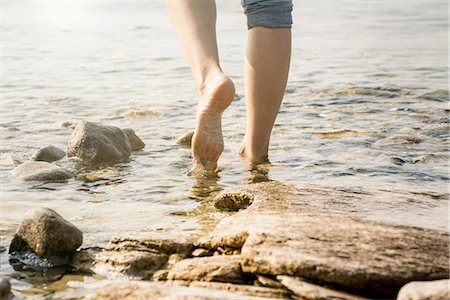 simsearch:649-09061376,k - Cropped view of woman barefoot in water Stock Photo - Premium Royalty-Free, Code: 649-09111188