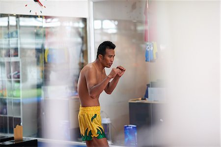 simsearch:649-09230700,k - Mid adult male boxer practicing in gym Stock Photo - Premium Royalty-Free, Code: 649-09111370