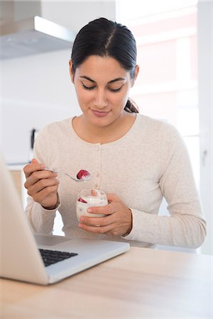 dairy technology - Woman eating fruits and yoghurt Stock Photo - Premium Royalty-Free, Code: 649-09111533