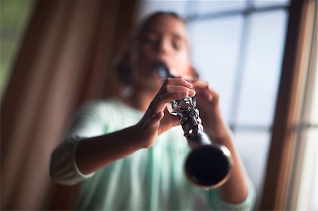 Young clarinettist playing her clarinet Stock Photo - Premium Royalty-Free, Code: 649-09111630