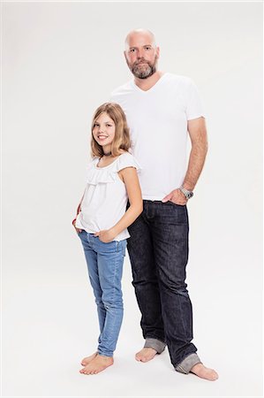 preteen girl in jeans - Studio portrait of mature man with daughter, full length Stock Photo - Premium Royalty-Free, Code: 649-09111657