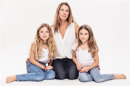 simsearch:649-09035507,k - Studio portrait of mature woman with two daughters sitting on floor Stock Photo - Premium Royalty-Free, Code: 649-09111653