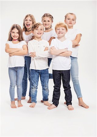 Studio portrait of two boys and four girls with arms folded, full length Stock Photo - Premium Royalty-Free, Code: 649-09111662