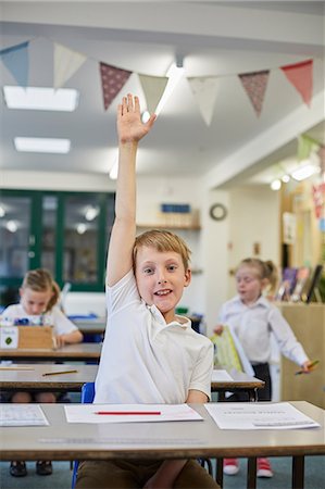 simsearch:649-07119796,k - Schoolboy with hand up in classroom at primary school Photographie de stock - Premium Libres de Droits, Code: 649-09111740