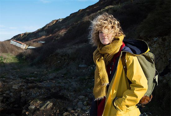 Portrait of girl with retro backpack hiking near former NATO fuel station on Normandy coast Photographie de stock - Premium Libres de Droits, Le code de l’image : 649-09123368