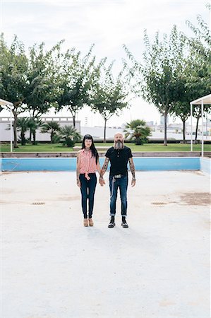 simsearch:649-09123411,k - Mature hipster couple standing in empty swimming pool, portrait, Valencia, Spain Stock Photo - Premium Royalty-Free, Code: 649-09123428