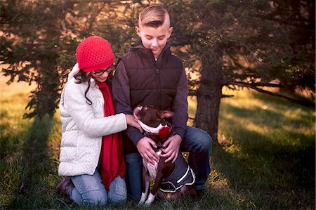 Portrait of girl and boy, with boston terrier dog, outdoors Stock Photo - Premium Royalty-Free, Code: 649-09123537