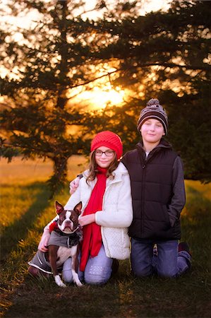 Portrait of girl and boy, with boston terrier dog, outdoors Stock Photo - Premium Royalty-Free, Code: 649-09123538