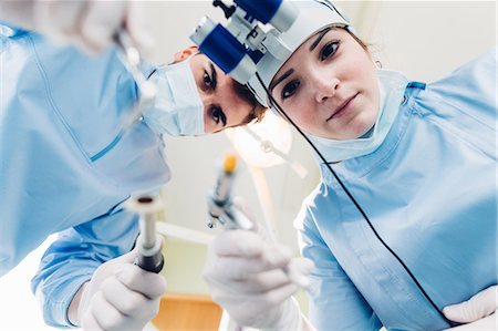 Dentist and dental nurse treating patient, personal persepctive Stock Photo - Premium Royalty-Free, Code: 649-09138893