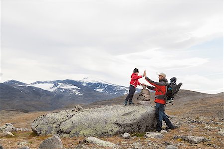 simsearch:649-09213649,k - Man with sons high fiving over cairn in mountain landscape, Jotunheimen National Park, Lom, Oppland, Norway Stock Photo - Premium Royalty-Free, Code: 649-09138953