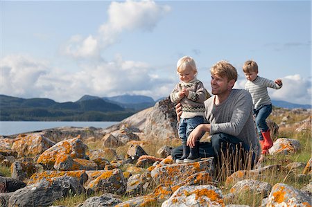 family, isolated, full length - Man with sons playing by fjord, Aure, More og Romsdal, Norway Stock Photo - Premium Royalty-Free, Code: 649-09138969