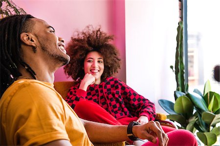 dreadlocks and woman - Young friends chatting indoors Stock Photo - Premium Royalty-Free, Code: 649-09139081