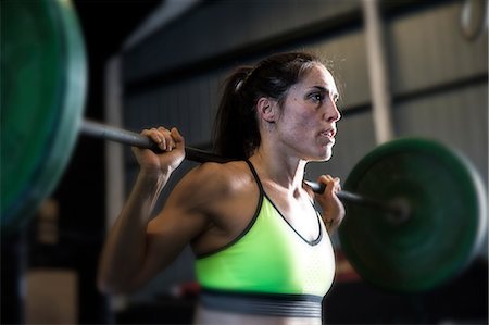 simsearch:649-07648175,k - Woman exercising in gym, using barbell Stock Photo - Premium Royalty-Free, Code: 649-09139124