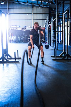 simsearch:649-09139139,k - Man exercising in gym, using battle ropes Stock Photo - Premium Royalty-Free, Code: 649-09139120