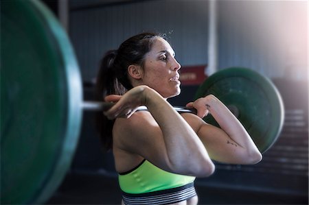 simsearch:649-07648175,k - Woman exercising in gym, using barbell Stock Photo - Premium Royalty-Free, Code: 649-09139123