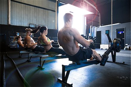 simsearch:614-09210734,k - Group of people exercising in gymnasium, using rowing machines, rear view Photographie de stock - Premium Libres de Droits, Code: 649-09139144