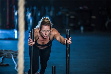 simsearch:649-09139139,k - Woman exercising in gymnasium, sled training Stock Photo - Premium Royalty-Free, Code: 649-09139146