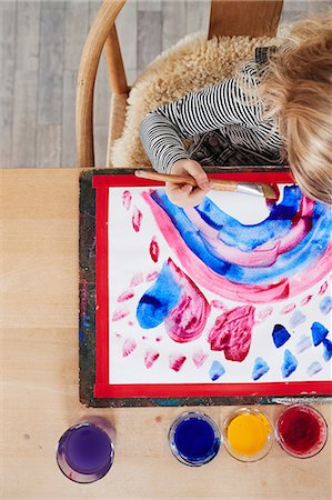 simsearch:6111-06838117,k - Young girl sitting at table, painting picture, overhead view Stock Photo - Premium Royalty-Free, Code: 649-09139242