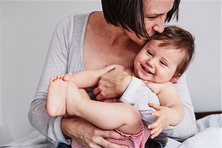 simsearch:700-06808775,k - Portrait of mother, hugging baby daughter Photographie de stock - Premium Libres de Droits, Code: 649-09139260