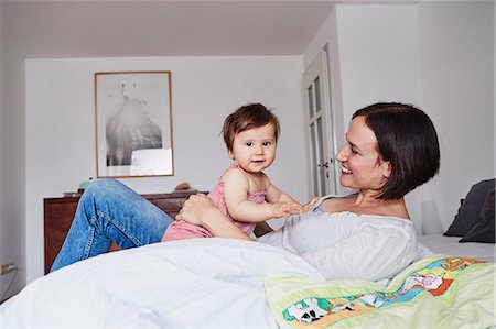 simsearch:649-08661261,k - Mother and baby daughter relaxing on bed Foto de stock - Royalty Free Premium, Número: 649-09139262