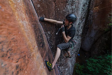 dangerous rock climbing - Rock climber climbing sandstone rock, elevated view, Liming, Yunnan Province, China Stock Photo - Premium Royalty-Free, Code: 649-09148469