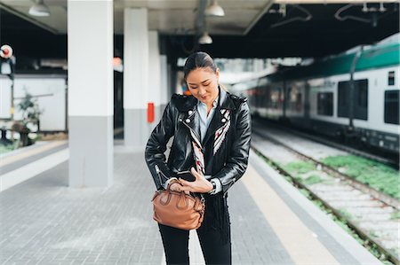 simsearch:649-09148924,k - Woman walking along train platform, going through bag, using smartphone Stockbilder - Premium RF Lizenzfrei, Bildnummer: 649-09148900