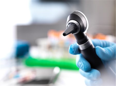 rubber gloves man - Cropped view of doctor holding otoscope Stock Photo - Premium Royalty-Free, Code: 649-09148998